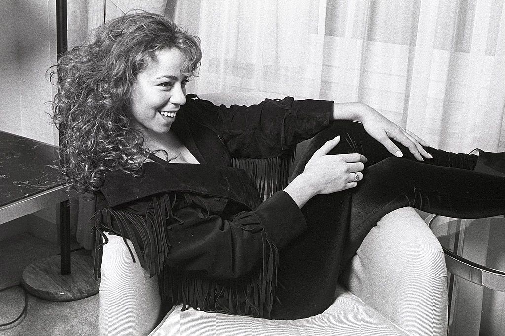 Mariah Carey posing on the sofa, 1991.