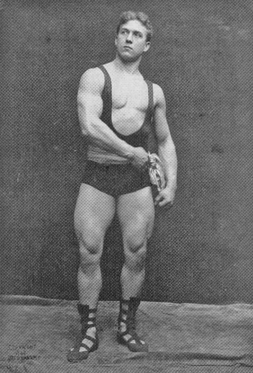 Lionel Strongfort. He began his famed stage career around 1897, becoming world-renowned for his “Human Bridge Act” (The Tomb of Hercules position)