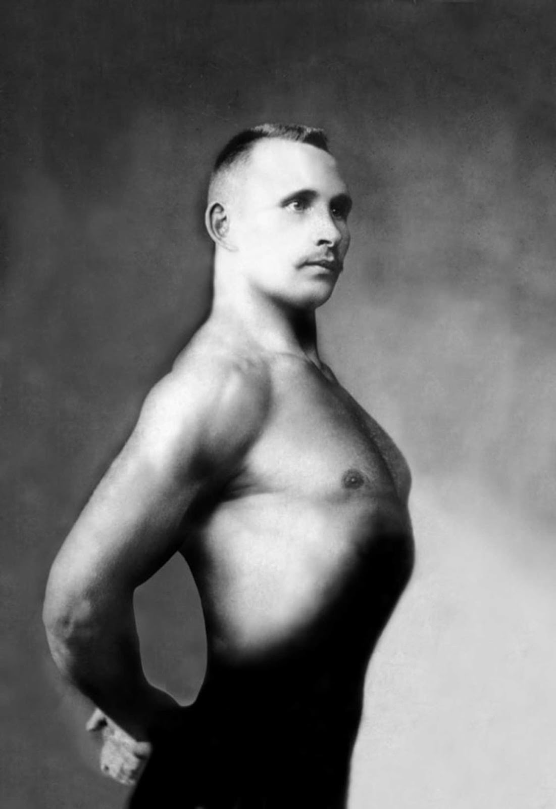 A Russian bodybuilder, photographed in a studio, 1900.