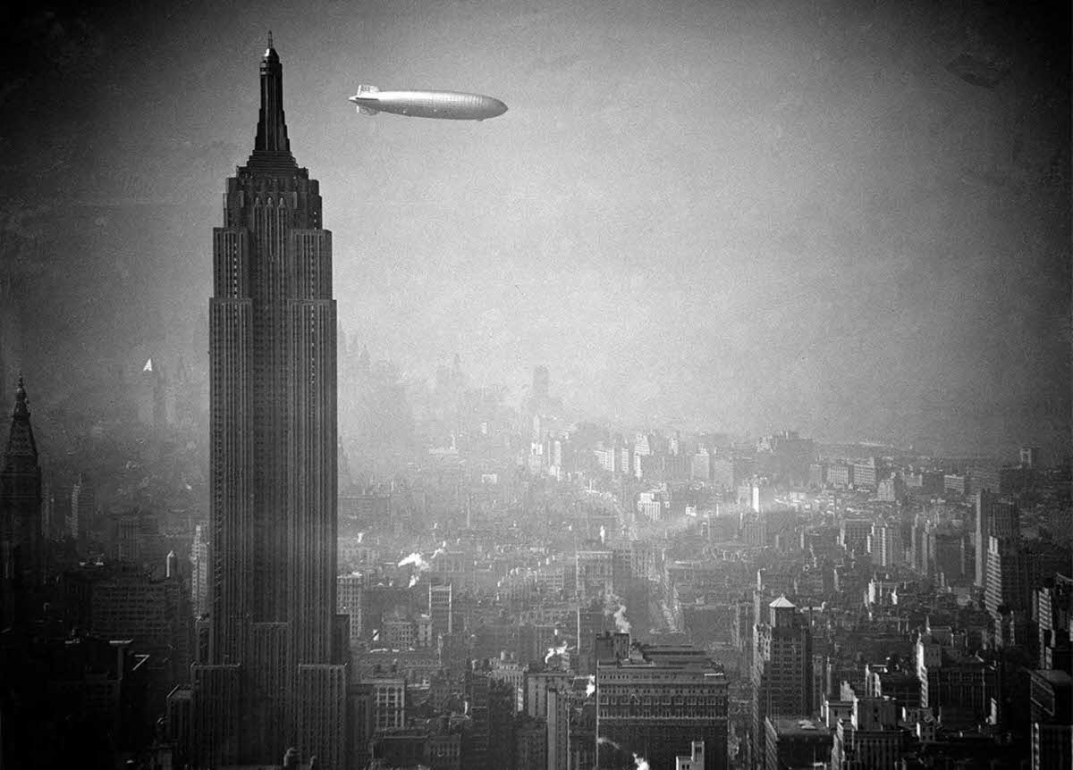 The German zeppelin Hindenburg floats past the Empire State Building over Manhattan, on August 8, 1936.