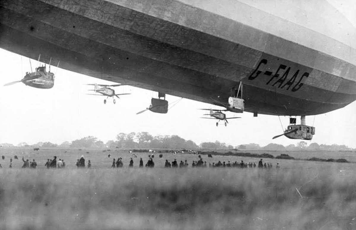 A pair of Gloster Grebe fighter planes, tethered to the underside of the British Royal Navy airship R33, in October of 1926.
