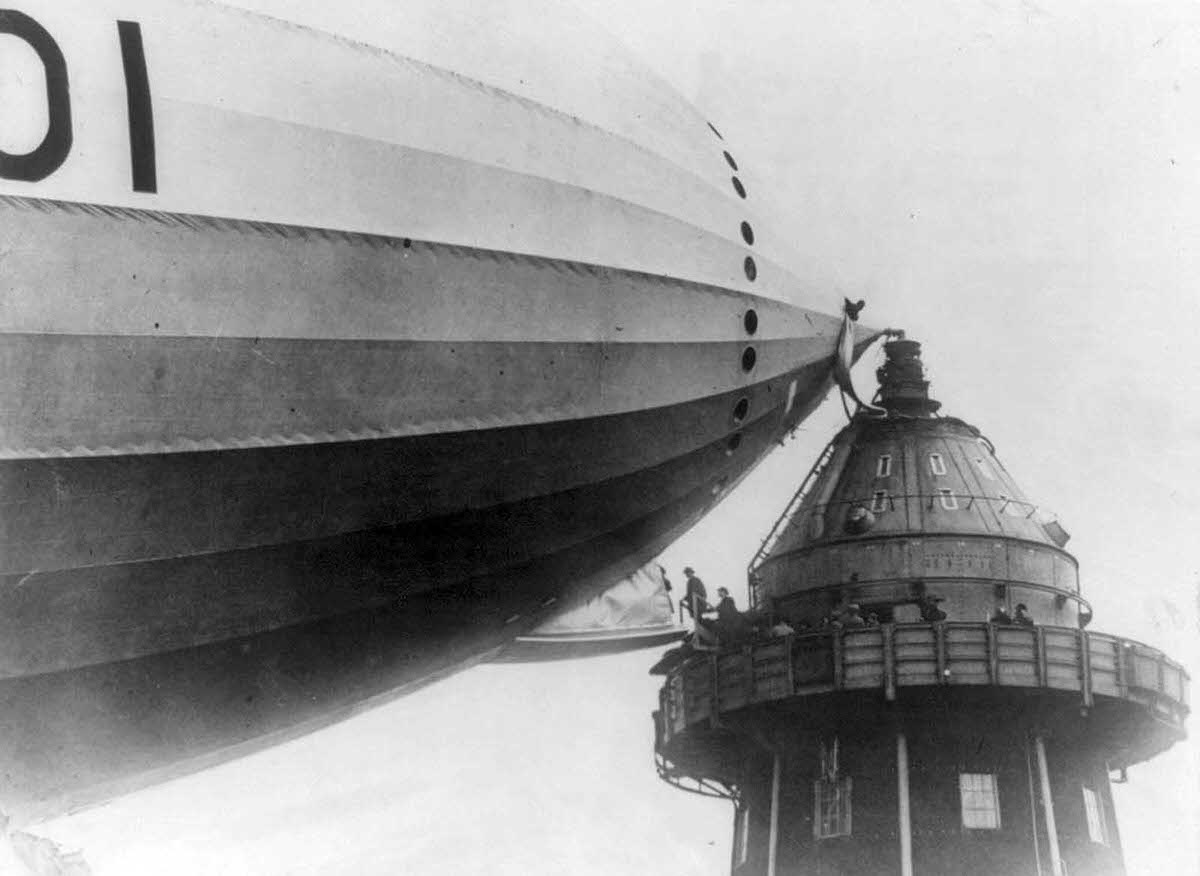 British M.P.s walk onto an airship gangplank, in Cardington, England, in the 1920s.