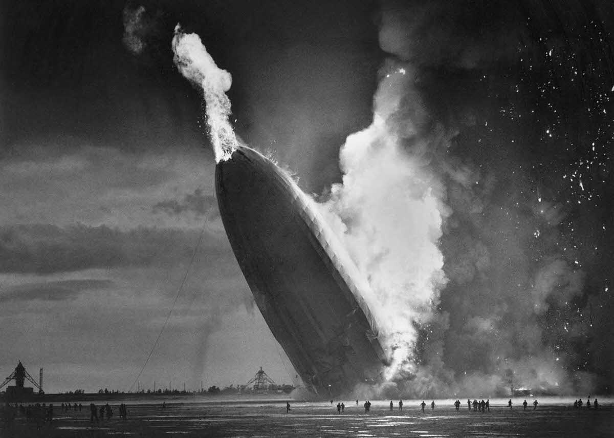 The German dirigible Hindenburg crashes to earth, tail first, in flaming ruins after exploding at the U.S. Naval Station in Lakehurst, New Jersey, on May 6, 1937.