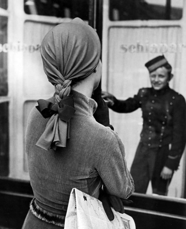 Model in suit and a whimsical cap with braid by Elsa Schiaparelli, photo by Regina Relang outside Schiaparelli’s store, Paris, 1951