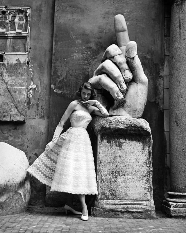 Model is wearing a strapless lace cocktail dress by the Fontana Sisters, photo by Regina Relang, Rome, 1952