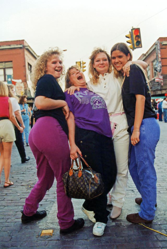 Four teenage girls pose on Exchange Avenue during the festival., Ft. Worth Stockyards, June 1993