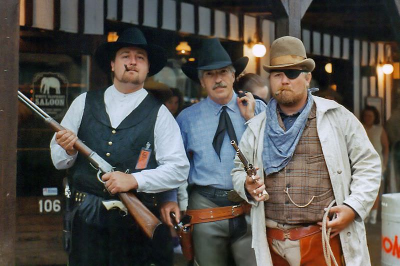 Three Western gunfighters pose by the White Elephant Saloon in the Ft. Worth Stockyards during a festival, likely Chisholm Trails Days, June 1994