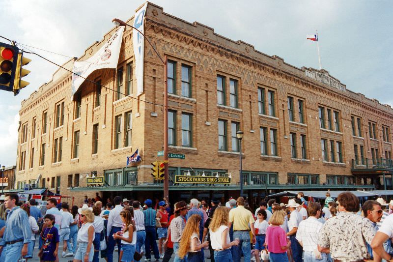 Crowds attending the festival in the Fort Worth Stockyards pass by the hotel, on the corner of Main Street and Exchange Avenue, June 1993