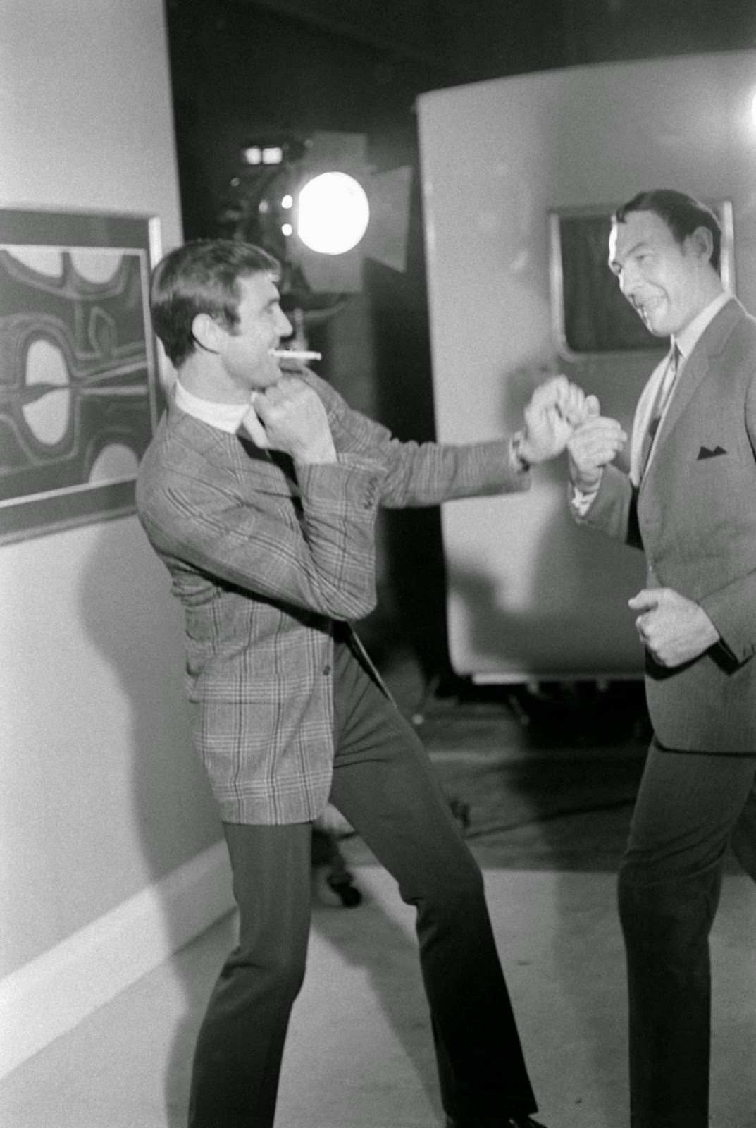 George Lazenby goofs off behind the scenes of his screen test, boxing with an unidentified man, 1967.