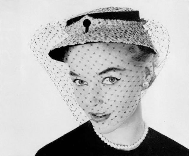 Joan Olson in small fine straw and black velvet cloche with silk voilette by Janette Columbier, 1953