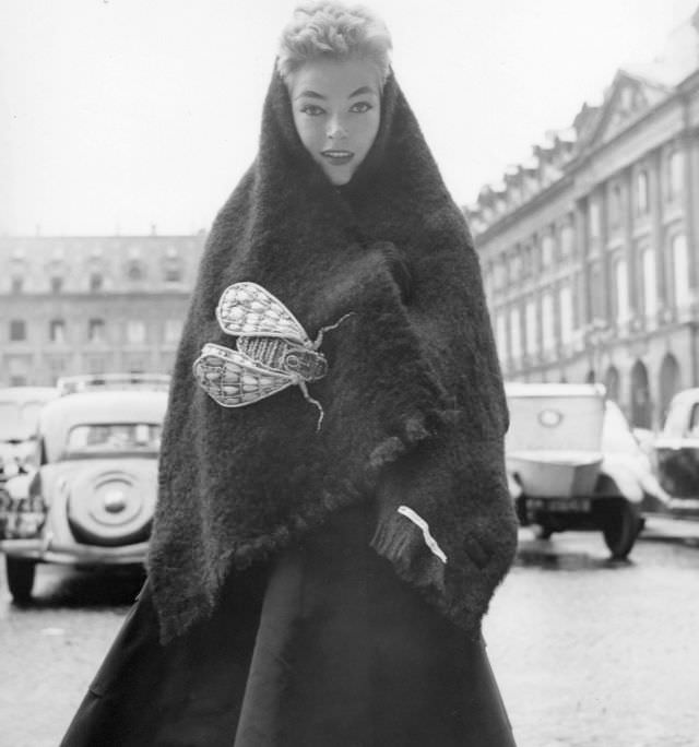 Joan Olson in black bouclé shetland stole with oversized insect pin, both by Schiaparelli, Paris, 1952