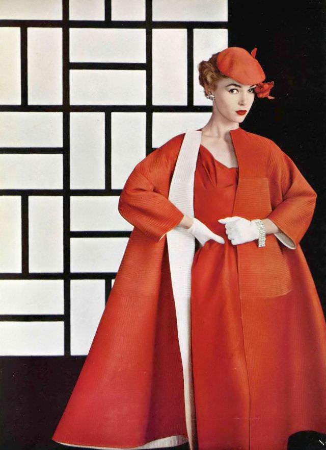 Joan Olson in dinner ensemble, coat is reversible red and white raw silk matelasse, quilting worked in both directions, worn over red silk dress, by Lanvin-Castillo, 1954