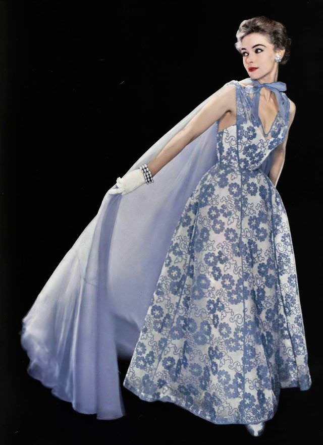Joan Olson in lilac organdy print evening dress with sheer organdy cape by Jean Dessès, bracelet by Vendôme, 1954