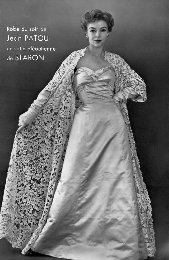 Joan Olson in satin evening gown worn with beautiful full-length lace coat, by Jean Patou, 1954