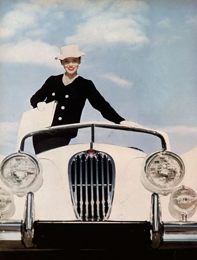 Joan Olson in black flannel sheath dress and double-breasted jacket by Donald Brooks for Darbury, 1957