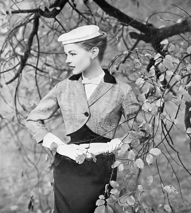 Joan Olson in black-and-white herringbone tweed short chesterfield jacket with black velvet collar and lined in red satin by Hayette, 1957.