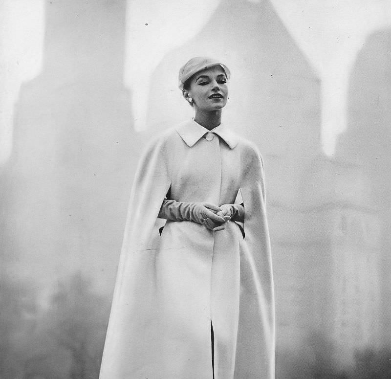 Joan Olson in white full-length cape of a light-weight tweed by Petite Juniors, chiffon hat by John Frederics Charmer, Harper's Bazaar, February 1957