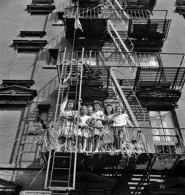 Italian-Americans watching parade on Mott Street and flag raising ceremony in honor of boys from the neighborhood in the United States Army, New York, New York, 1942