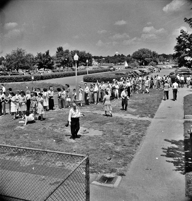 Line of prospective swimmers, awaiting their turn at the municipal swimming pool on Sunday in Washington, D.C., June 1942