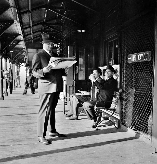 Men waiting for the Third Avenue elevated train in the Fifties at 8-30 a.m., New York, New York, September 1942