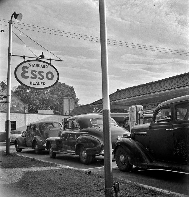 Morning of July 21st, the last day before stricter gas rationing went into effect, cars were parked in front of gas stations, Washington, D.C., 1942