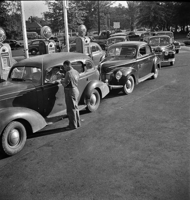 Morning of July 21st, the last day before stricter gas rationing went into effect, cars were parked in front of gas stations long before they opened, waiting to fill their tanks, Washington D.C., 1942