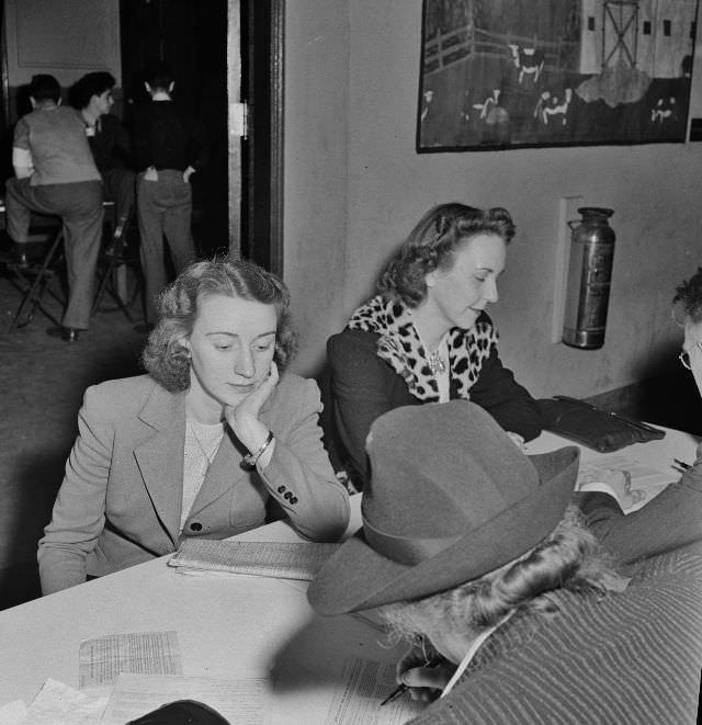 Residents of one of Washington DC's best residential sections apply for sugar ration cards at Adams School, May 1942