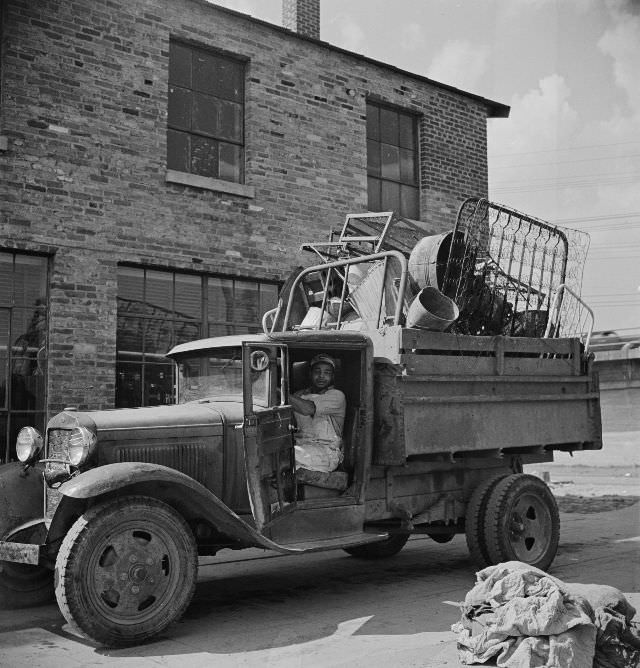 Truck loaded with scrap metal is weighed on platform scale before being unloaded in wholesale junkyard during the salvage campaign, Victory Program, Washington, D.C., May 1942