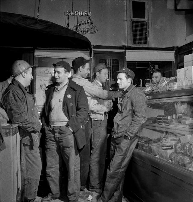 Third shift defense workers waiting in a combination delicatessen and restaurant to be picked up by their car pools around midnight, Baltimore, Maryland, April 1943