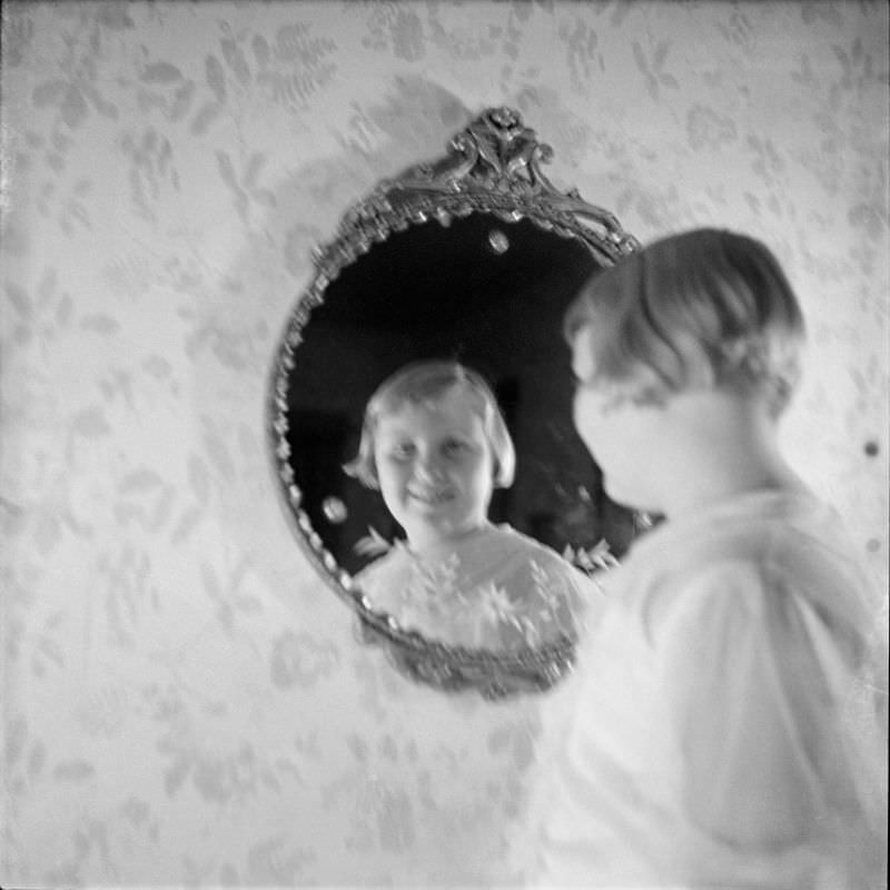 Louise Buckner standing and looking into a mirror