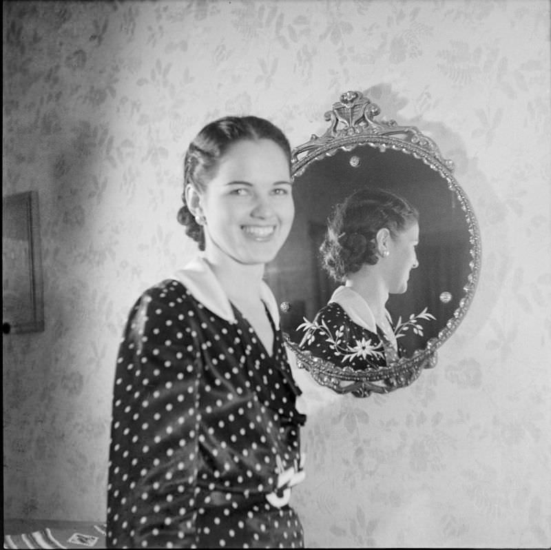 A woman standing in front of a mirror