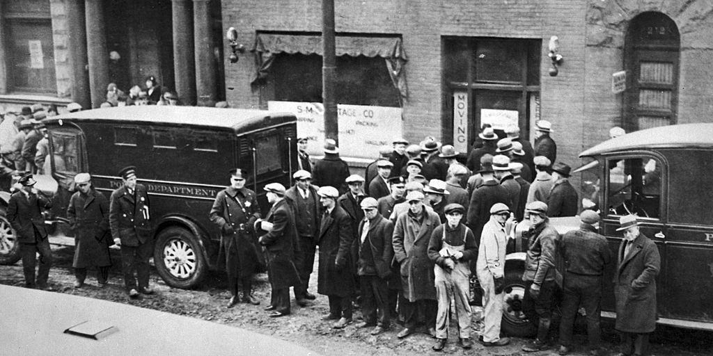 Police and spectators gather in front of the infamous garage where the St. Valentine's Day Massacre occurred, Chicago 1929.