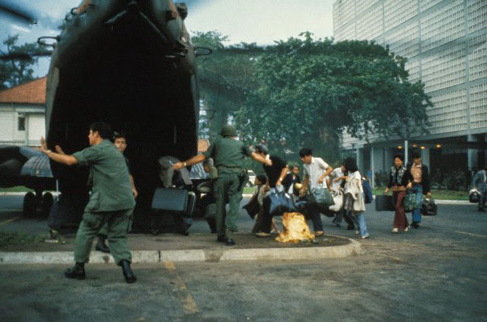 US civilians board helicopter inside the American Embassy compound in Saigon to escape advancing North Vietnamese about to capture Saigon.