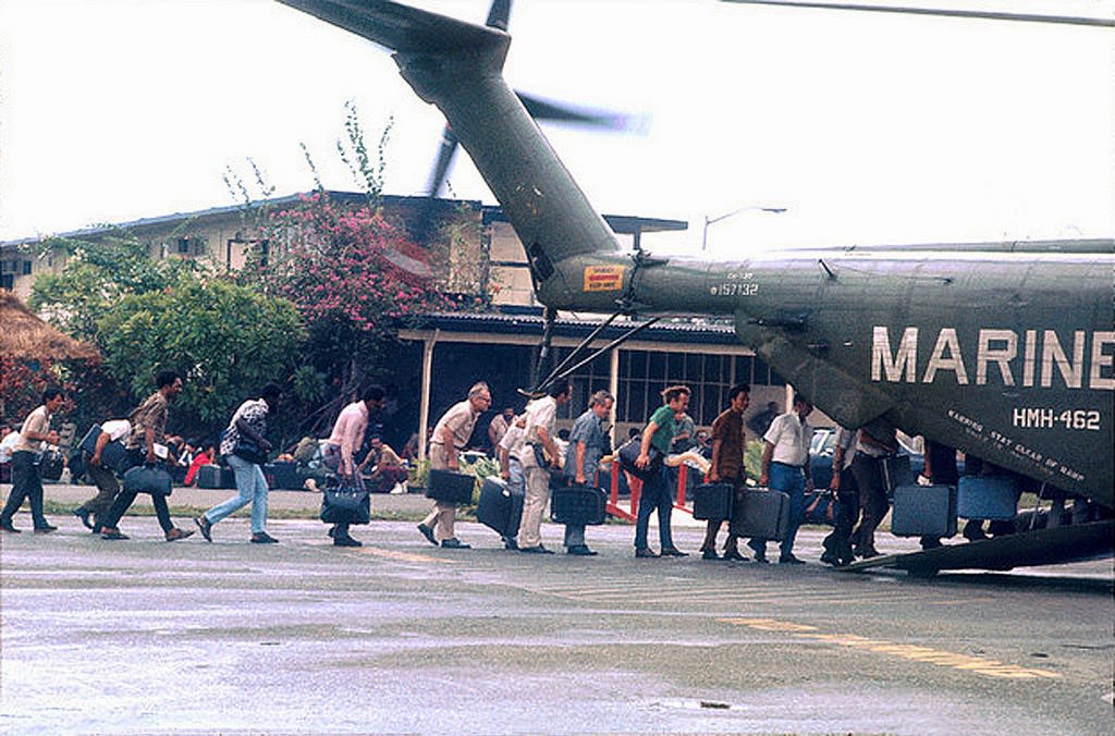 Marines guard the evacuation of civilians at Tan Son Nhut airbase in Vietnam while under Viet Cong fire, during the fall of Saigon, on April 15, 1975