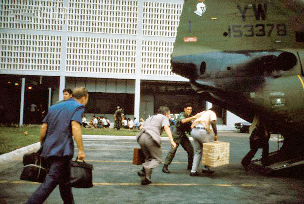 Civilian evacuees board US Marine helicopter inside US Embassy compound to be helilifted to the US Seventh Fleet ahead of Communist troops about to enter Saigon.