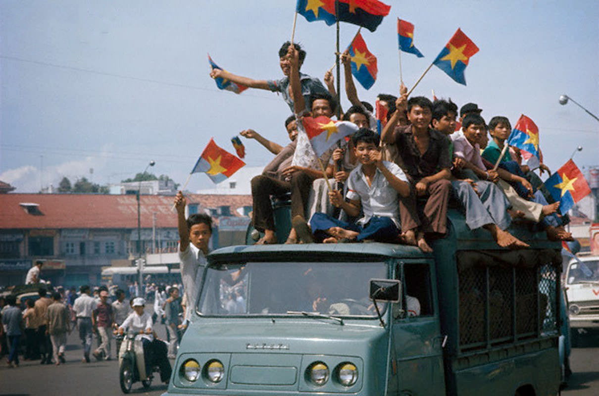 Vietnamese celebrate after the fall of Saigon, 30 Apr 1975.