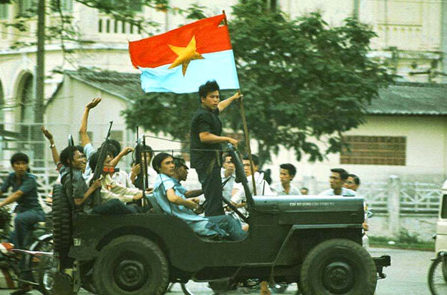 A jeep willis with on board elements of the GRP (Provisional Revolutionary Government) South Vietnamese traverses Saigon announcing the arrival of the north-Vietnamese tanks.