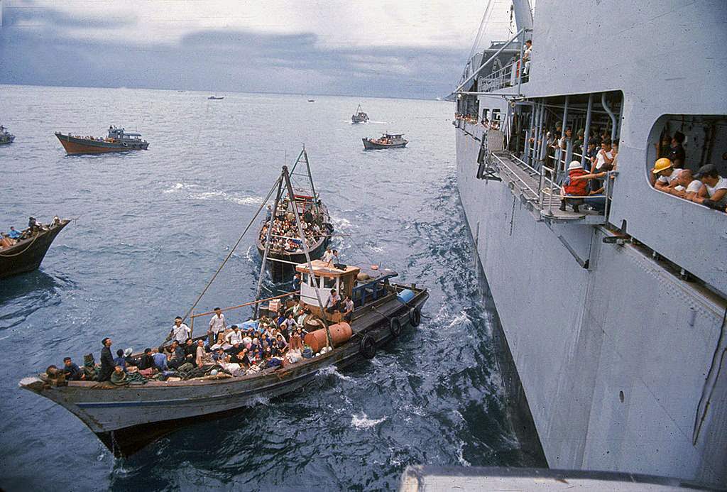 South Vietnamese refugees in boats approach a U.S. war ship to seek refuge from the invading force from the North April 1975 in the South China Sea near Saigon.