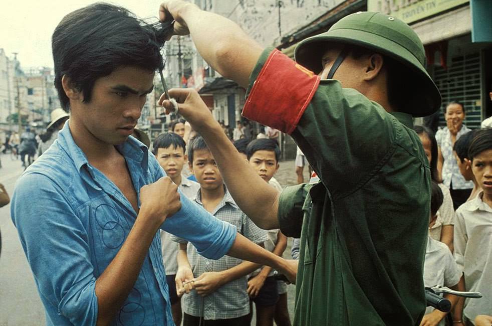 The Vietcong cutting hair and "western" clothes.