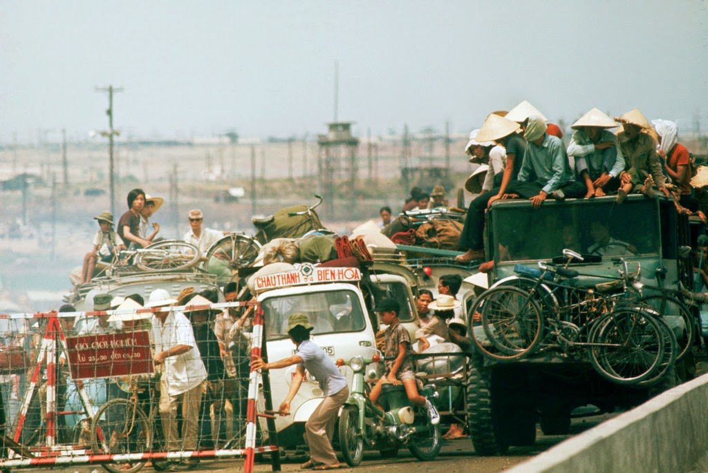 A street congested with traffic as refugees flee in automobiles to Saigon near the end of the Vietnam War.