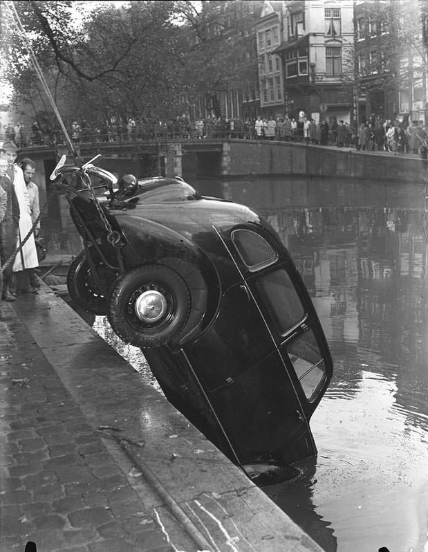 A car being pulled from the canal in Amsterdam, 1940s.