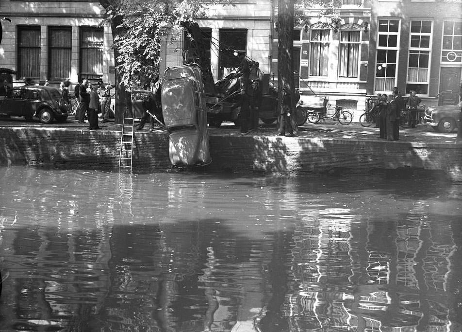 A car being pulled from the canal in Amsterdam, 1940s.