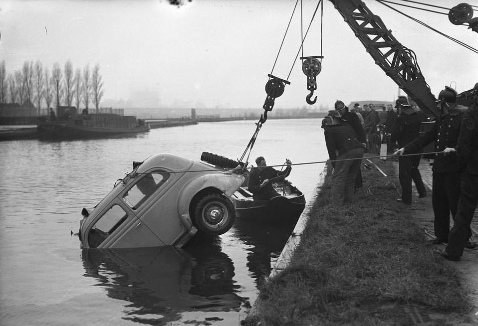 A car being pulled from the canal in Amsterdam, 1945.