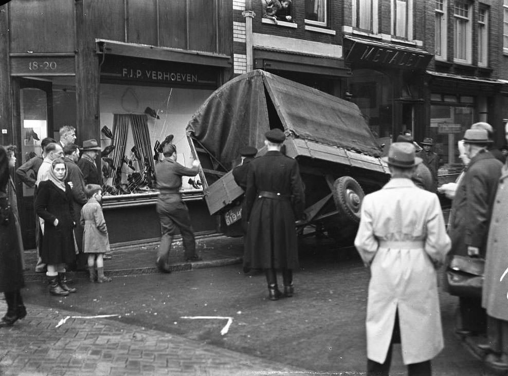 Delivery struck by the shop window in Amsterdam, 1940s.