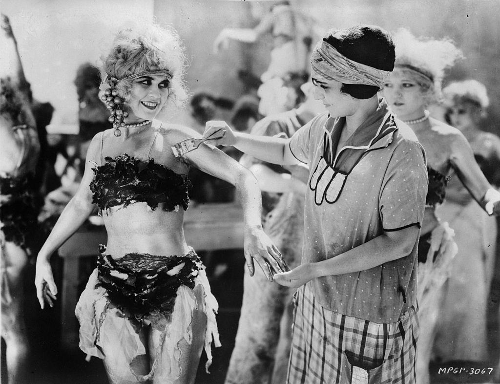 Alice Terry has body paint applied by a make-up artist before filming commences, 1924.