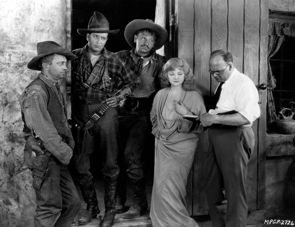 Alice Terry discuss the next scene with director Reginald Barker, on the set of the MGM film 'The Great Divide', 1925.