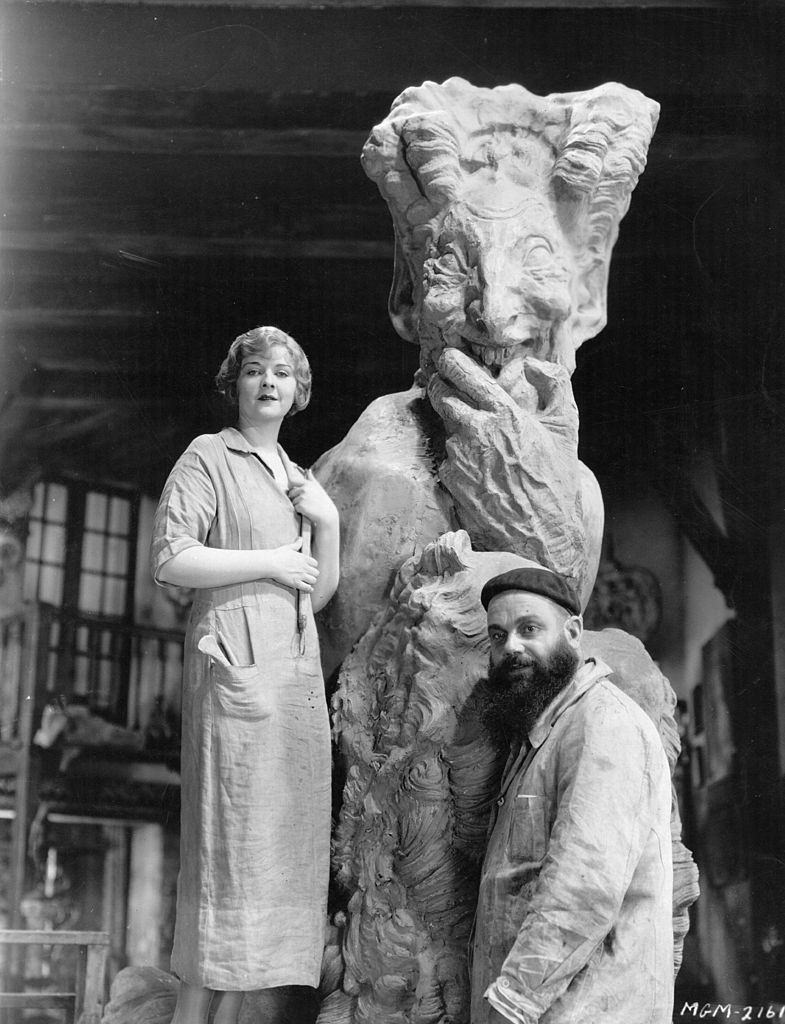 Alice Terry with Paul Darde, the leading European sculptor and his enormous creation which is part of the equipment for her forthcoming film 'The Magician', 1925.