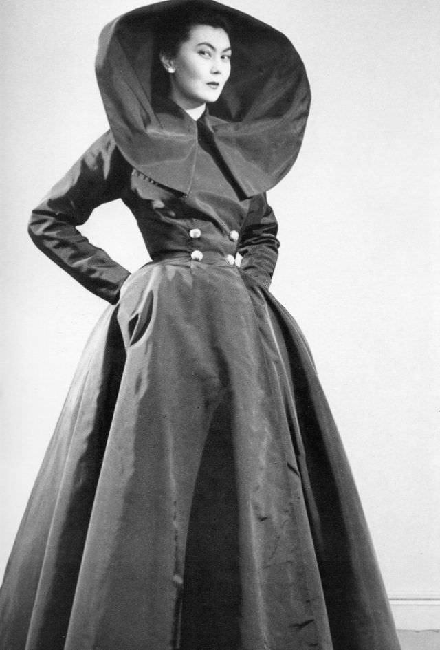 Alla wears Dior's 'Carnavalet', a full black taffeta evening dress with an enormous collar, 1949