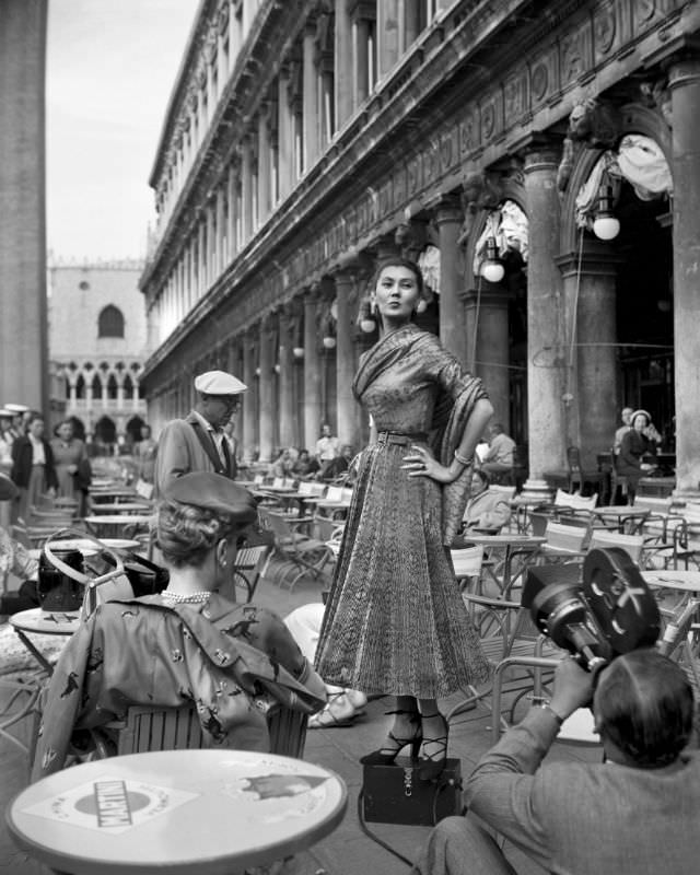 Alla wearing a Christian Dior dress is being filmed at a cafe on the Piazza San Marco in Venice, 3rd June 1951