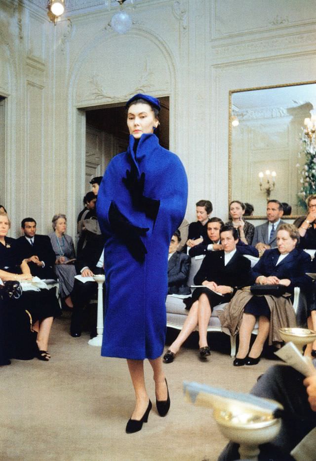 Alla in blue wool version of Dior's cape-coat, Autumn/Winter Collection H-line 1954, Maison Dior, Paris
